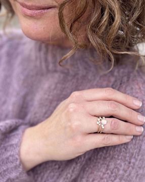 Gullring med rosenkvarts i senter og diamanter ned langs sidene.